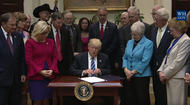 Signing the bill. Photo by White House.