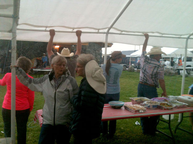 Holding down the canopies. Photo by Dawn Ballou, Pinedale Online.