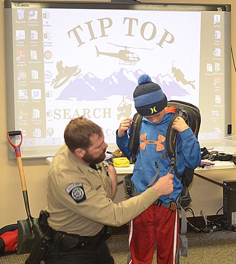 Tip Top Trainer Shawn Fits Volunteer with Float. Photo by Terry Allen.